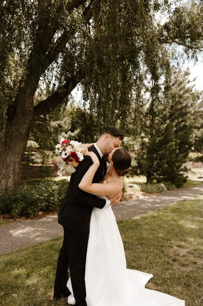 bride and groom on their wedding day kissing for the photographer