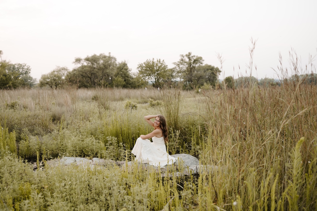 senior posing for a senior photographer