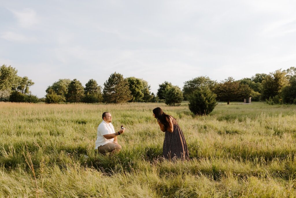 couple posing for a camera as a photographer takes their photo