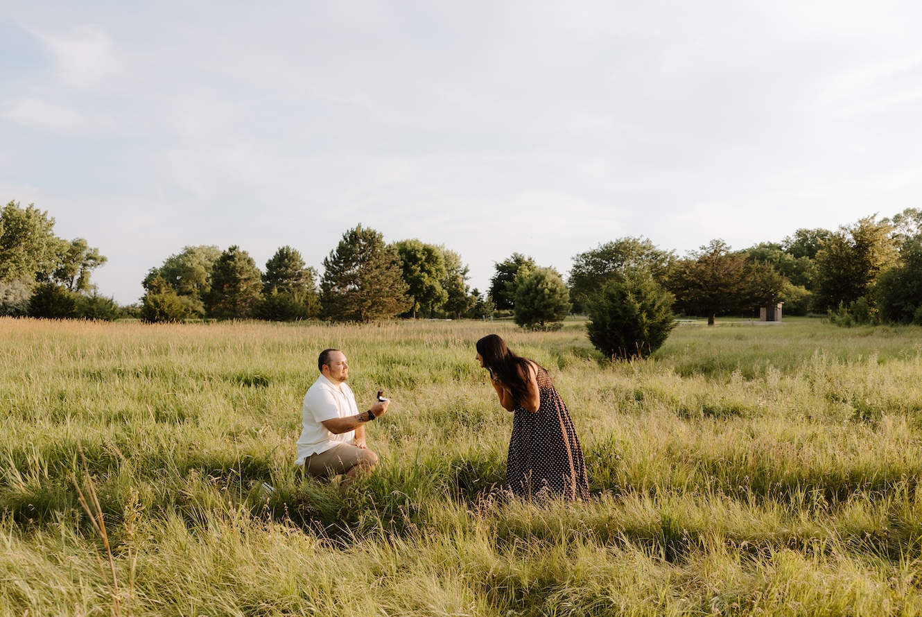 couple posing for a camera as a photographer takes their photo