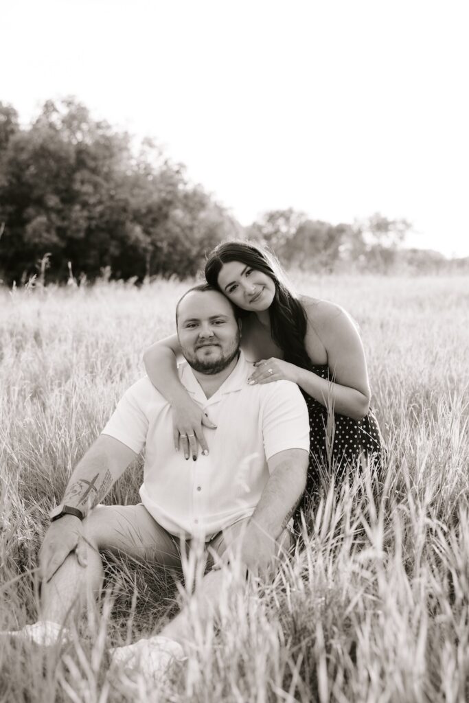 couple posing for a camera as a photographer takes their photo