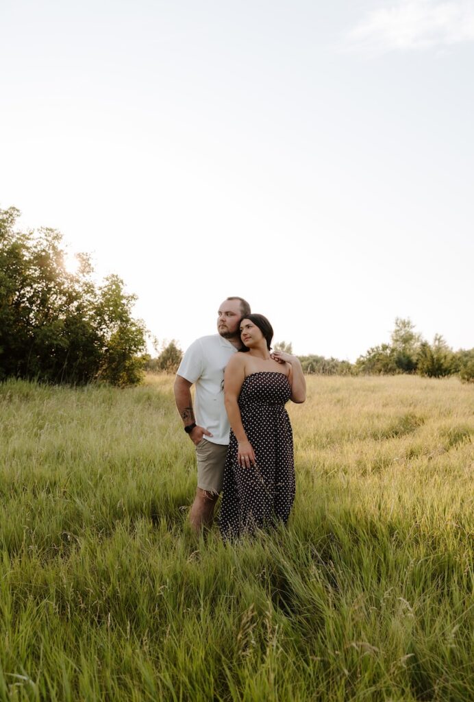 couple posing for a camera as a photographer takes their photo