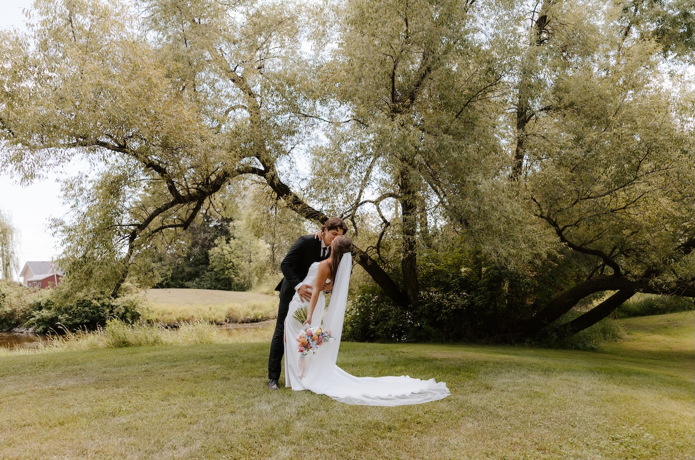 bride and groom posing for a wedding photo by a wedding photographer